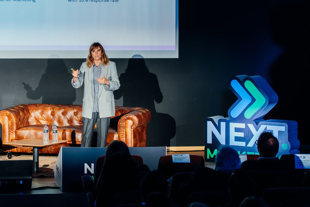 Orador em palco na 1.ª Conferência NEXT.MARKETING, com a audiência em primeiro plano